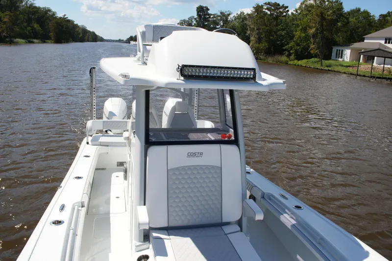 Slide: The Image of 2024 Costa Custom Boats 264HC on a scenic river, showcasing sleek design and modern features. - 49