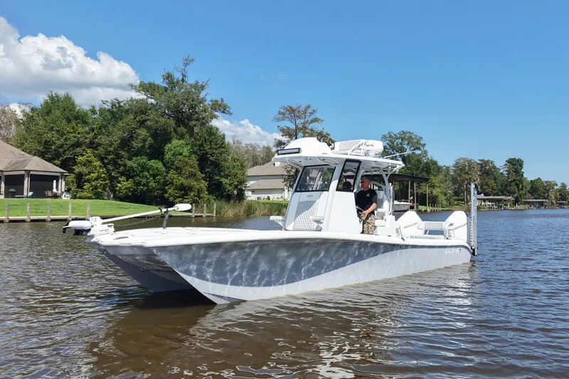 Slide: The Image of 2024 Costa Custom Boats 264HC on a serene lake, surrounded by lush greenery. - 15