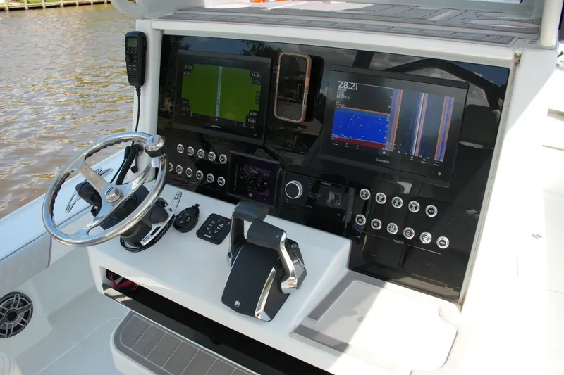 Slide: The Image of 2024 Costa Custom Boats 264HC helm with advanced navigation displays and controls. - 30
