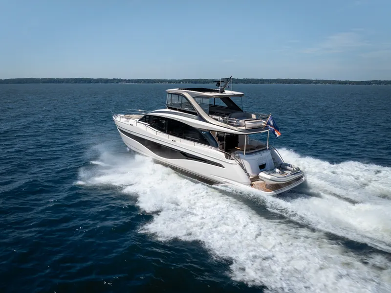 Slide: The Image of The 2025 Princess Y72 speeds across the water, with a flag at the stern. - 4