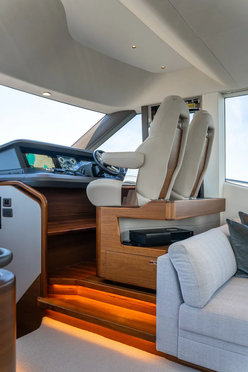 Slide: The Image of The image shows a yacht cockpit with two cushioned seats and a modern helm station. - 27