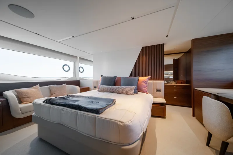 Slide: The Image of Luxurious cabin with a large bed, modern furnishings, and large windows on a yacht. - 36