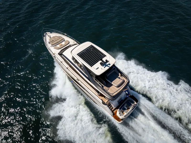 Slide: The Image of The 2025 Princess Y72 speeds across the water, featuring sleek design and spacious deck. - 5