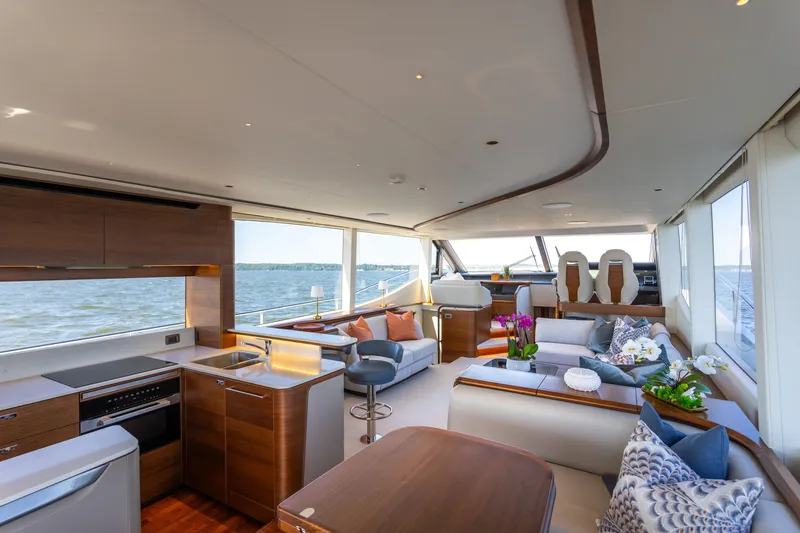 Slide: The Image of The luxurious interior of the 2025 Princess Y72 features an elegant seating area and modern kitchen. - 18