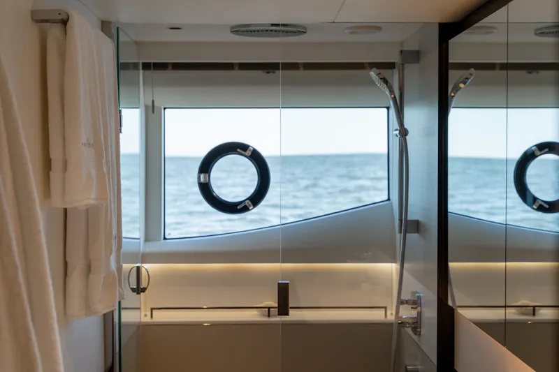 Slide: The Image of A luxurious yacht bathroom with an ocean view through a porthole. - 43