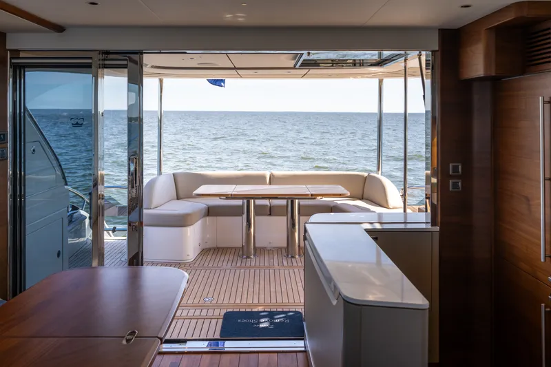 Slide: The Image of Interior view of a luxury yacht with sea view, wooden floors, and elegant furnishings. - 9