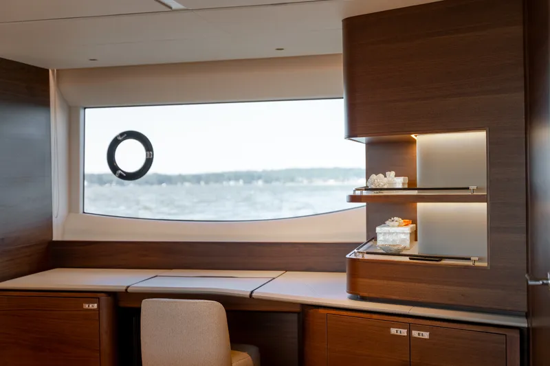 Slide: The Image of Interior of the 2025 Princess Y72 featuring elegant wood furnishings and a large window with sea view. - 39