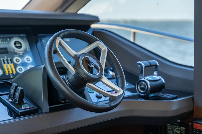 Slide: The Image of The cockpit of the 2025 Princess Y72 features a modern steering wheel and digital displays. - 31