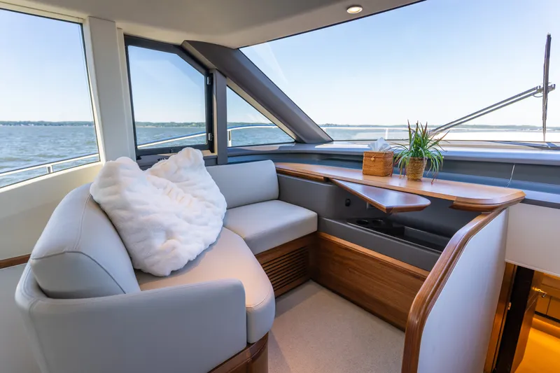 Slide: The Image of Elegant interior of the 2025 Princess Y72 with a cozy seating area and panoramic water views. - 25