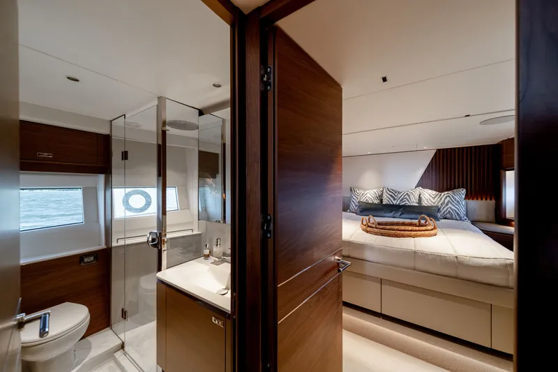 Slide: The Image of Luxurious cabin of the Princess Y72 with a double bed, bathroom, and elegant wood finishes. - 45