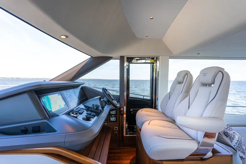 Slide: The Image of The image shows the cockpit of a luxury yacht with two white leather seats and a modern helm. - 28