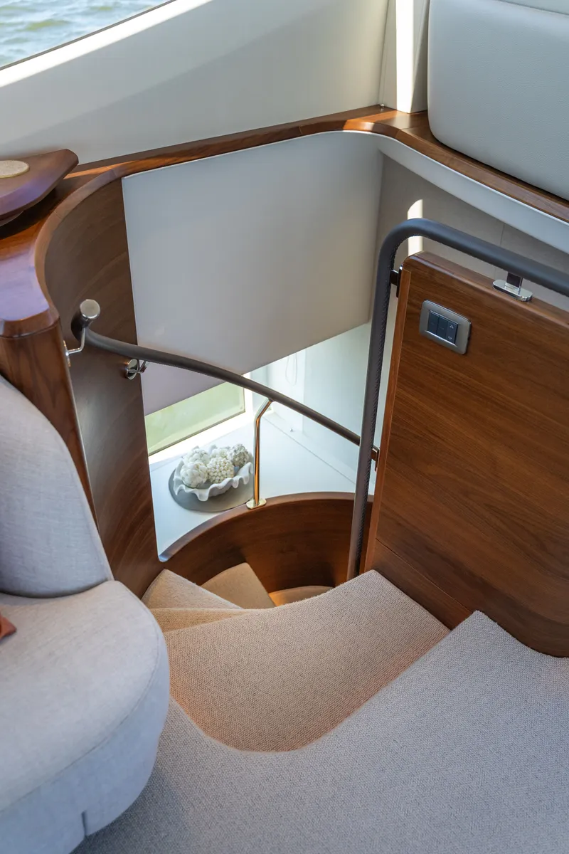Slide: The Image of Elegant staircase with wooden railing and carpeted steps in a luxury yacht. - 34