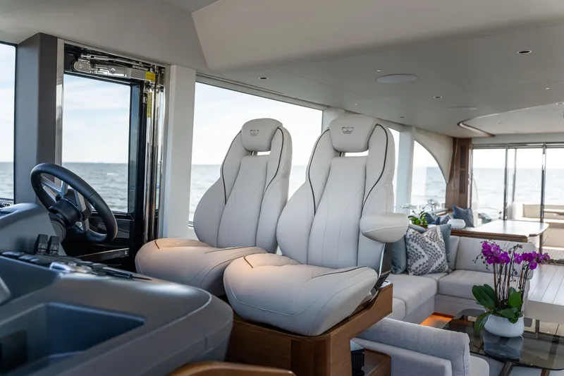 Slide: The Image of Luxurious interior of a Princess Y72 yacht with sleek white seats and ocean view. - 29