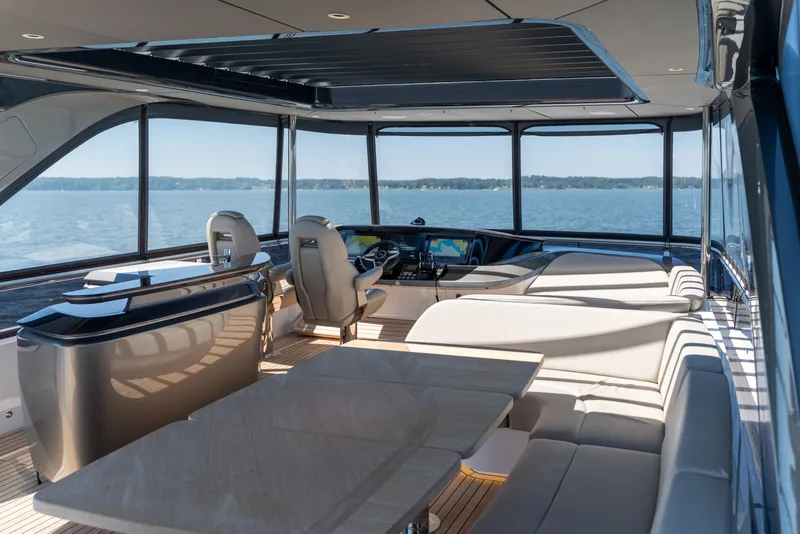 Slide: The Image of The image shows the luxurious interior of a 2025 Princess Y72 yacht with panoramic water views. - 2