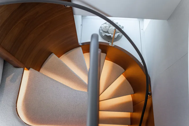 Slide: The Image of Elegant spiral staircase with wood and carpet accents in a luxurious yacht. - 35