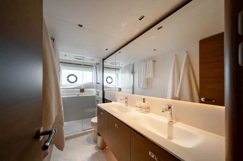 Slide: The Image of Luxurious bathroom with double sinks, mirrored wall, and shower on the Princess Y72 yacht. - 41