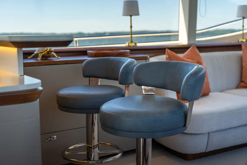 Slide: The Image of Interior of the Princess Y72 with blue bar stools and beige sofa, stylish and modern. - 16