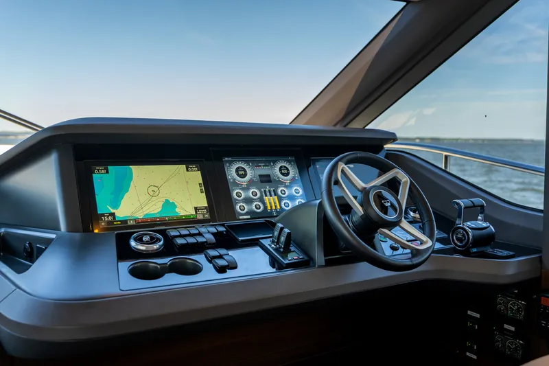 Slide: The Image of The cockpit of the 2025 Princess Y72 features modern navigation and control systems with a sleek steering wheel. - 30