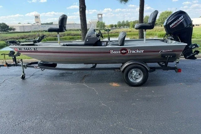 The Image of 2019 Tracker Bass Tracker Classic XL fishing boat on trailer, parked outdoors. - 0