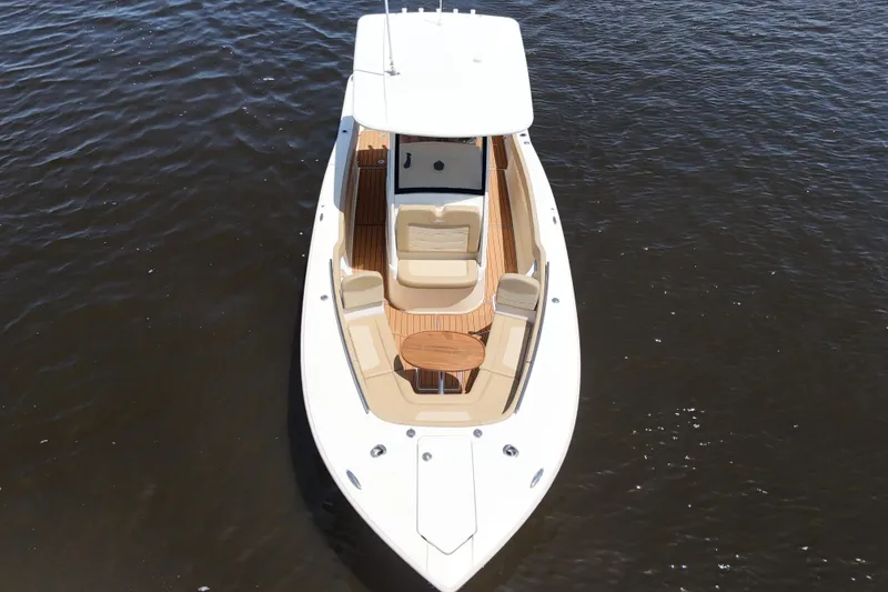 Slide: The Image of 2021 Scout 277 LXF boat on water, featuring sleek design and spacious seating. - 33