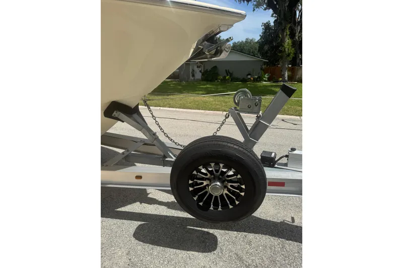 Slide: The Image of Trailer with 2021 Scout 277 LXF boat, featuring a stylish wheel design. - 40