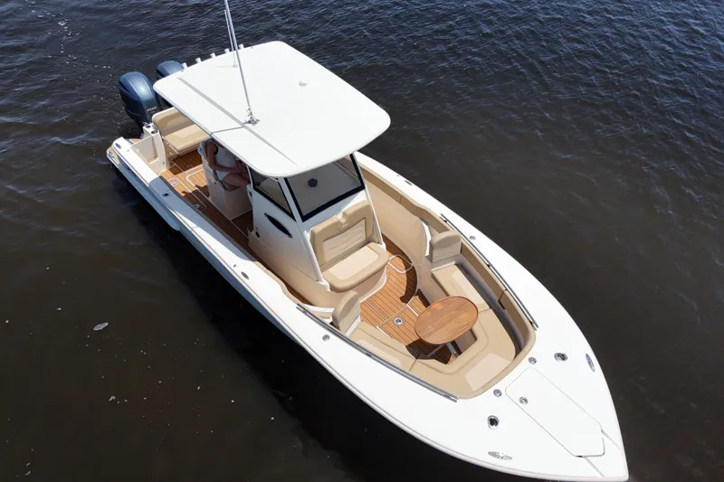 Slide: The Image of 2021 Scout 277 LXF boat on water, featuring sleek design and spacious deck. - 32