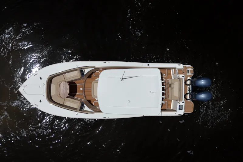 Slide: The Image of Overhead view of 2021 Scout 277 LXF boat on dark water. - 31