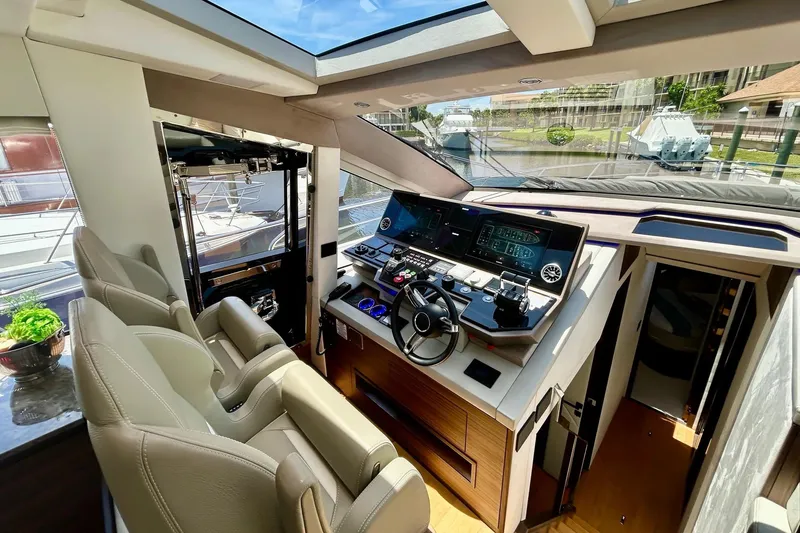Slide: The Image of Luxurious 2024 Aicon 66 yacht cockpit with modern navigation controls and plush seating. - 19