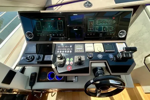 Slide: The Image of Modern yacht control panel with dual screens and advanced navigation system, 2024 Aicon 66 model. - 18