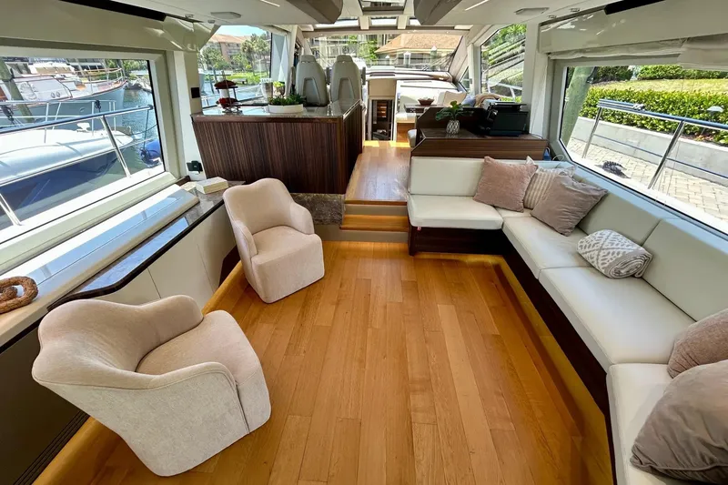 Slide: The Image of Luxurious 2024 Aicon 66 yacht interior with elegant seating and wooden flooring. - 24