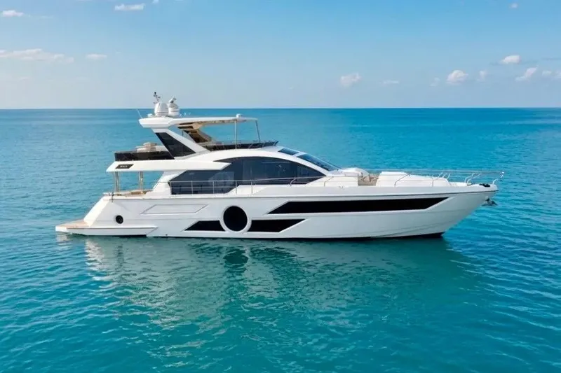 The Image of Luxurious 2024 Aicon 66 yacht cruising on clear blue ocean waters. - 1