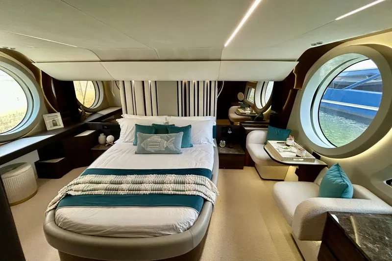 Slide: The Image of Luxurious 2024 Aicon 66 yacht bedroom with elegant decor and large circular windows. - 17