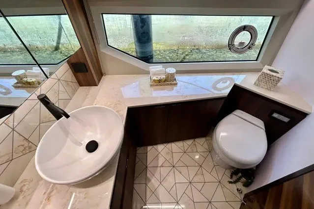 Slide: The Image of Luxurious 2024 Aicon 66 yacht bathroom with modern sink, toilet, and large window. - 14