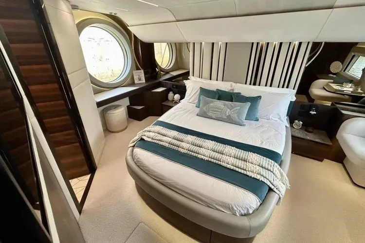Slide: The Image of Luxurious 2024 Aicon 66 yacht bedroom with elegant decor and round windows. - 30