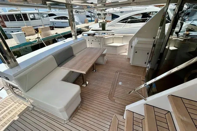 Slide: The Image of Luxurious 2024 Aicon 66 yacht deck with elegant seating and wooden flooring. - 28