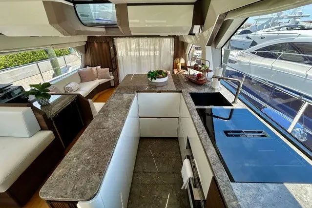 Slide: The Image of Luxurious 2024 Aicon 66 yacht interior with modern kitchen and elegant seating area. - 20