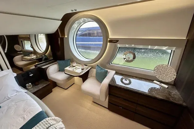 Slide: The Image of Luxurious 2024 Aicon 66 yacht interior with elegant seating and large circular windows. - 15