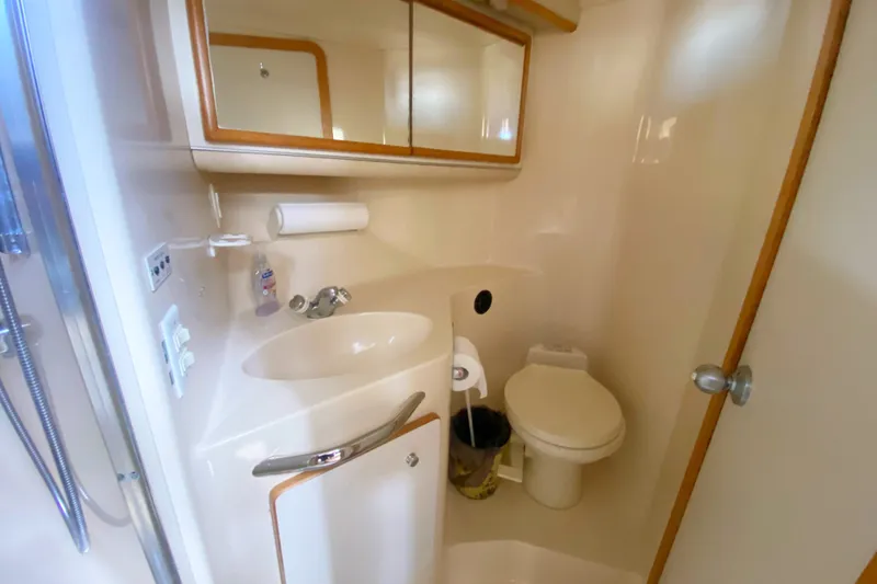 Slide: The Image of Bathroom interior of 1996 Sea Ray 440 Express Bridge yacht, featuring sink and toilet. - 30