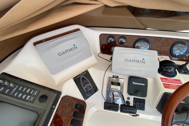 Slide: The Image of Control panel of a 1996 Sea Ray 440 Express Bridge with Garmin and Raymarine equipment. - 40
