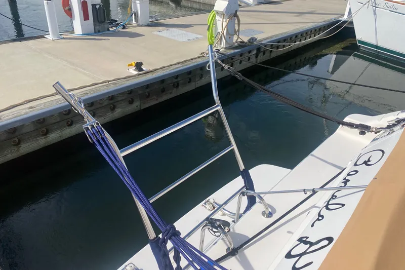 Slide: The Image of Docked 1996 Sea Ray 440 Express Bridge with mooring lines and dock equipment. - 48