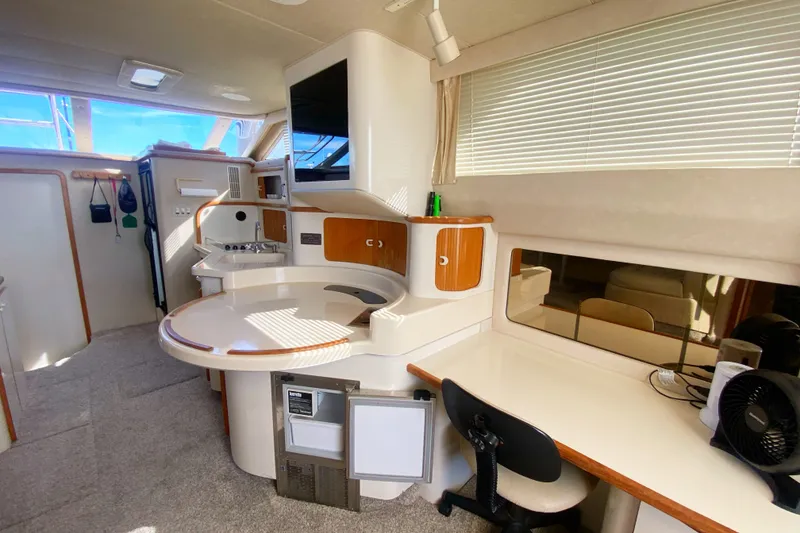 Slide: The Image of Interior of 1996 Sea Ray 440 Express Bridge yacht with modern amenities and seating area. - 15