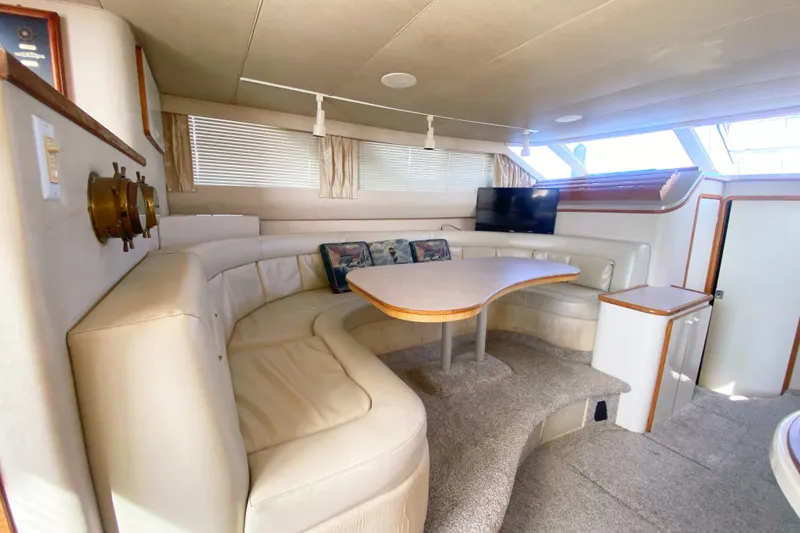 Slide: The Image of Interior of 1996 Sea Ray 440 Express Bridge with plush seating and modern decor. - 23