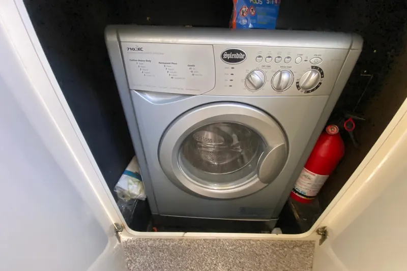 Slide: The Image of Splendide washing machine in a 1996 Sea Ray 440 Express Bridge yacht compartment. - 24