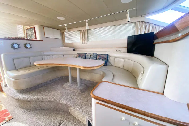 Slide: The Image of Luxurious 1996 Sea Ray 440 Express Bridge interior with plush seating and modern amenities. - 22