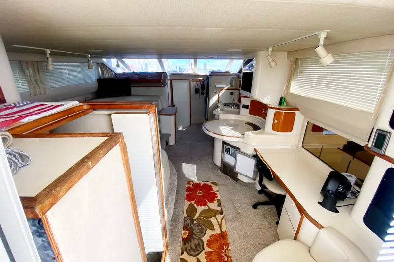 Slide: The Image of Interior of a 1996 Sea Ray 440 Express Bridge yacht, featuring a modern, spacious design. - 12
