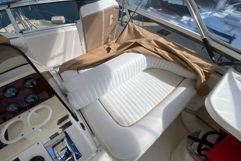 Slide: The Image of 1996 Sea Ray 440 Express Bridge interior with white seating and control panel. - 41