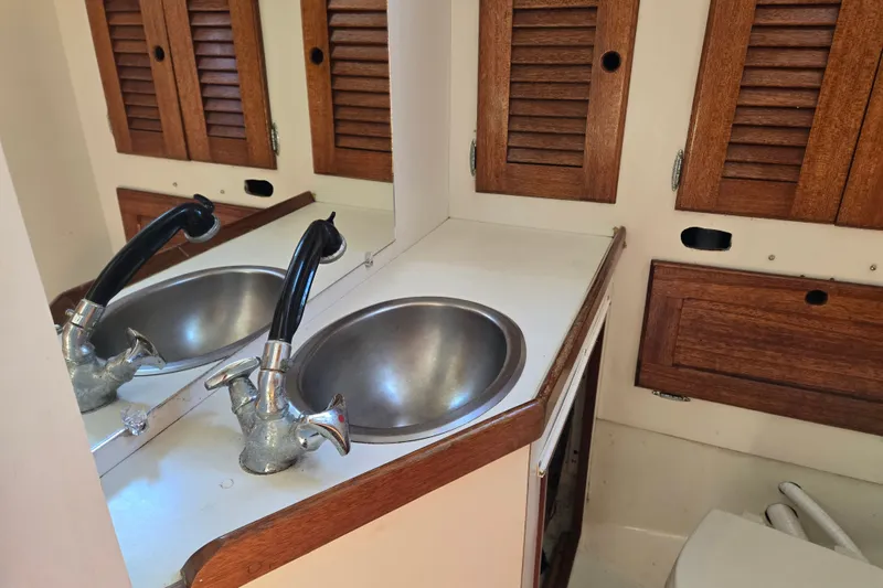 Slide: The Image of 1978 Bristol 35.5 yacht bathroom with wooden cabinets and stainless steel sink. - 22