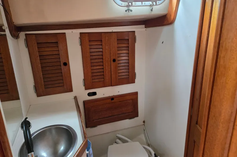 Slide: The Image of 1978 Bristol 35.5 yacht bathroom with wooden cabinets and stainless steel sink. - 20