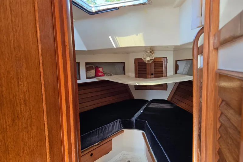 Slide: The Image of 1978 Bristol 35.5 sailboat interior with wooden finish and cozy sleeping area. - 17