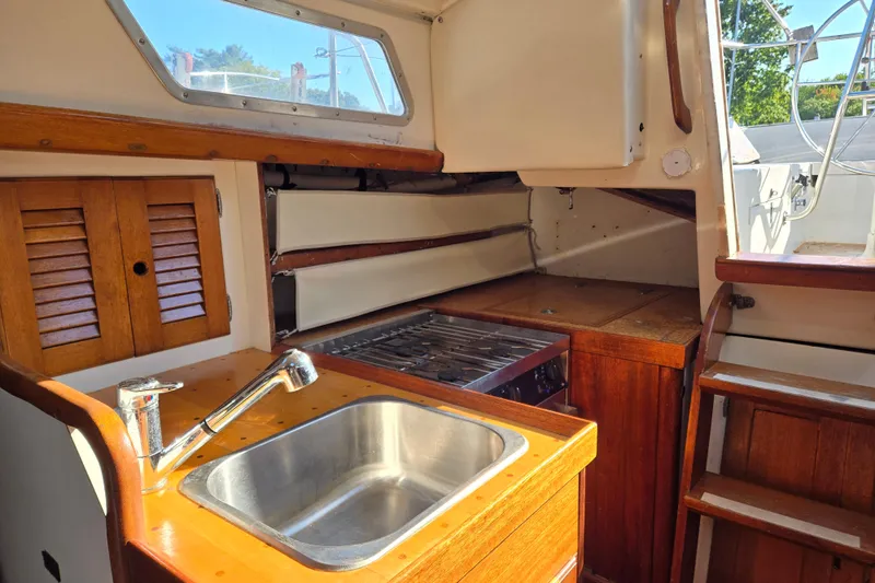 Slide: The Image of 1978 Bristol 35.5 yacht interior with wooden cabinetry, sink, and stove. - 24